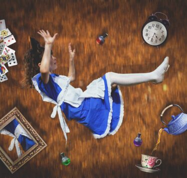 girl falling down hole with objects around her