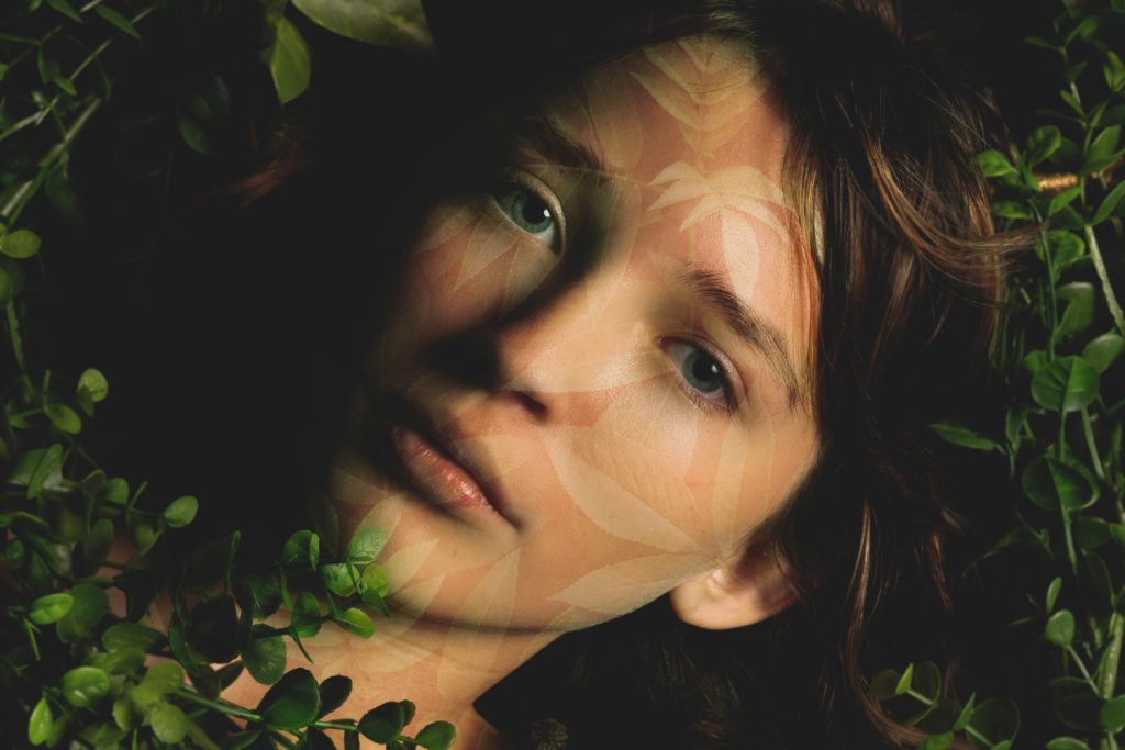 girl laying in leaves