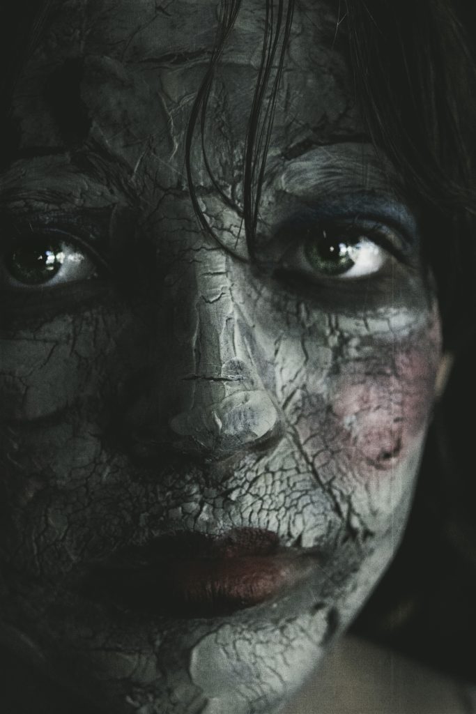 close up of a girl wearing doll makeup