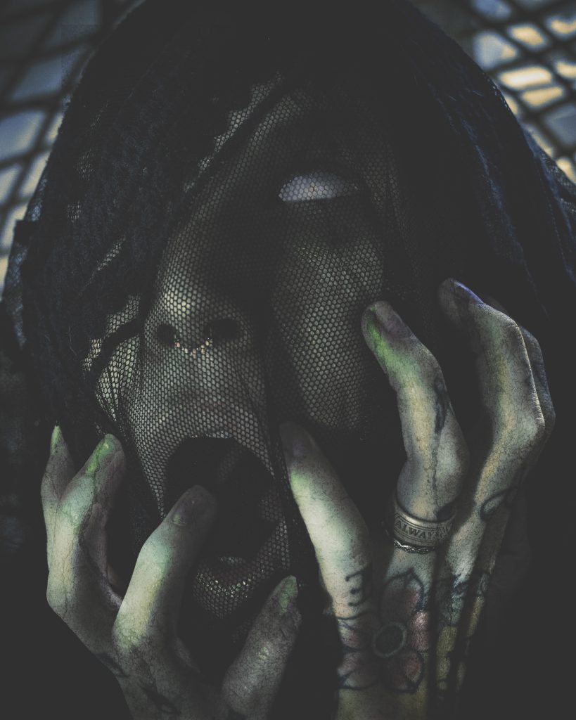 spooky close up of face with hands