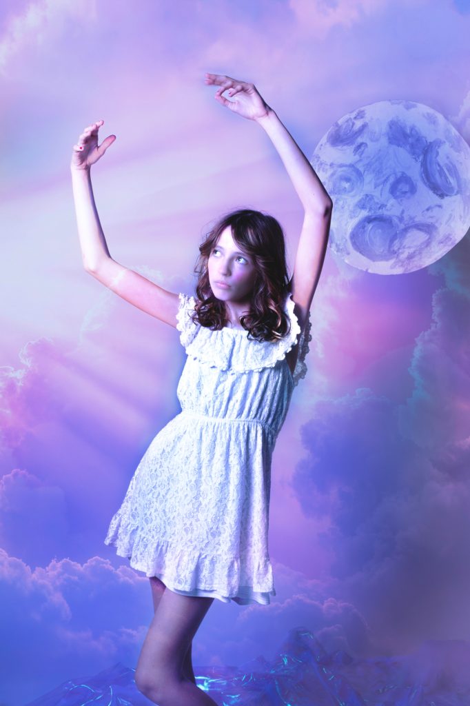girl in dreamy clouds with moon