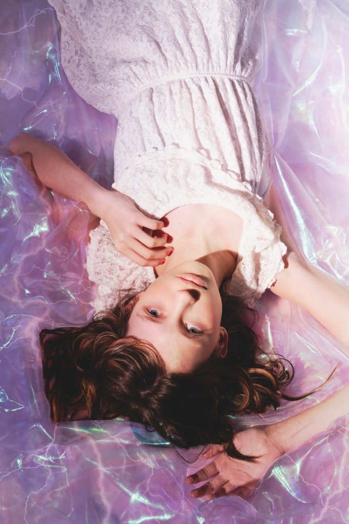 girl sleeping on iridescent clouds