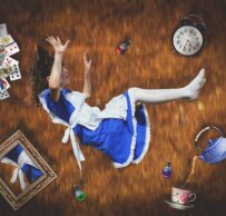 girl falling down hole with objects around her